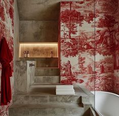 the bathroom is decorated with red and white wallpaper, along with stone steps that lead up to an outdoor bathtub