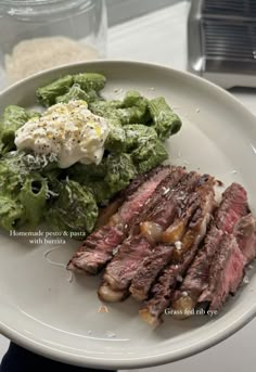 steak, lettuce and potato salad on a white plate