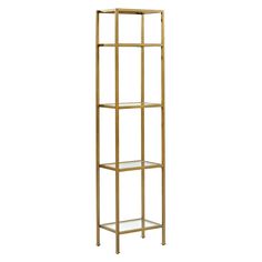 a tall gold metal shelf with glass shelves