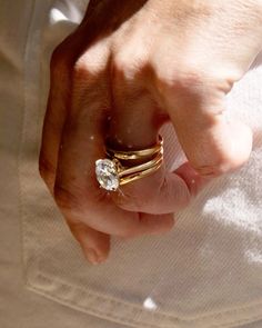 a close up of a person's hand holding a ring