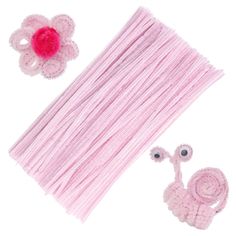 pink crocheted hair accessories including a flower, and a pair of eyeballs