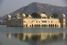 a large building sitting on top of a lake