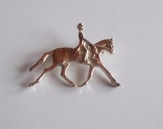 This is a sterling silver dressage horse pin / brooch.  It is in nice condition, no scratches etc. It is marked 925 for sterling silver. This pin has just been sitting in a jewelry box and has never been used.  The locking pin works fine. It measures 1 3/8" long x 1" tall. Nice gift for the dressage rider, eventer or horse lover. Weighs 4.9gm. Very Nice  PLEASE NOTE: I do not clean vintage silver as I like the patina of old silver, you may too. Classic Formal Jewelry With Horse Design, Formal Silver Jewelry With Horse Design, Elegant Horse Design Jewelry For Shows, Elegant Jewelry With Horse Design For Shows, Horse Event, Show Horse, Equestrian Jewelry, Horse Pony, Pony Club