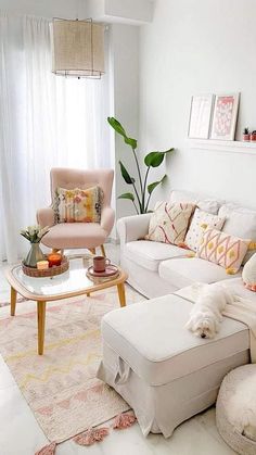 a living room filled with white furniture and lots of pillows