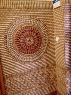 a bathroom with a tiled wall and toilet in it's corner, next to a wooden door