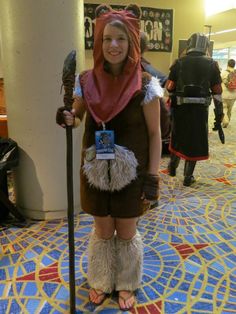 a woman dressed in costume standing on the floor