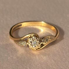 a close up of a gold ring with a diamond on it's center stone