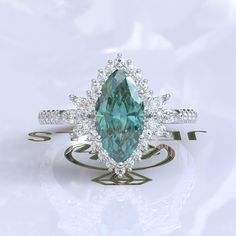 a fancy ring with a large green stone surrounded by diamonds