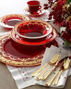 a red and gold place setting on a table