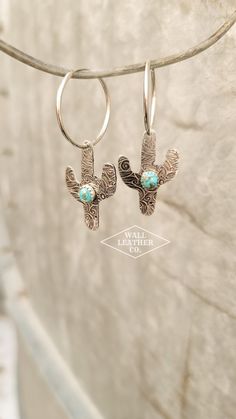 Say hello to the perfect touch of western and turquoise! These earrings feature a tarnished paisley pattern and a 6mm authentic turquoise stone. The earrings feature a hoop, which pulls open to put the earrings in. The metal cactus cutout is made of aluminum, so it is hypoallergenic, safe in water, and lightweight. The turquoise stone is riveted down, so you won't risk losing it. Please note that I have a variety of shades of turquoise, ranging from very blue to very green. It will be a gamble which shade you get! Please add to the order notes at checkout if you desire a specific shade, but keep in mind that it is subject to what I have on hand.  The tarnished effect is faux, so it may gradually wear off over time, with use. Because each and every pair of earrings are made to order, please Handmade Western Turquoise Earrings, Turquoise Dangle Earrings Western Style, Turquoise Southwestern Hoop Earrings, Diamond Wrap Ring, Turquoise Nickel-free Western Earrings, Country Rings, Cactus Earrings, Turquoise Nickel-free Southwestern Earrings, Shades Of Turquoise