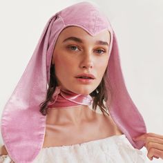 a woman wearing a pink bonnet and dress