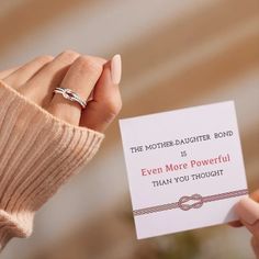 a woman holding up a card with the words, the love between mother and daughter is forever