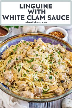 linguine with white clam sauce in a blue bowl on a wooden table