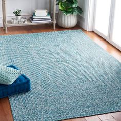 a blue rug on the floor in a living room