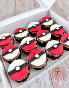 twelve cupcakes in a white box with red and black frosting, each decorated like a pikachu