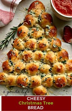 a cheesy christmas tree bread is on a plate