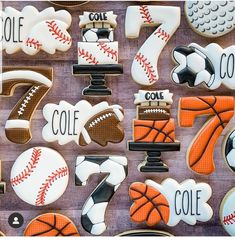 cookies decorated with sports and numbers are displayed on a wooden table for the guests to eat