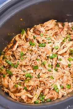 shredded chicken and green onions in a slow cooker