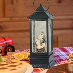 there is a small lantern on the table next to some cookies and other food items