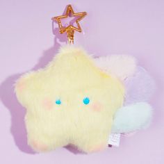 a yellow star shaped plush toy with blue eyes on a purple and pink background,