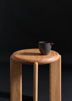 a small wooden table with a bowl on it