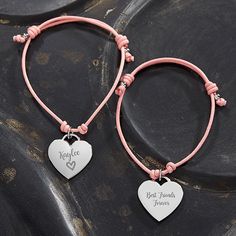 two bracelets with heart charms on them