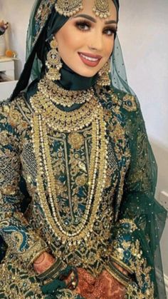 a woman in a green and gold wedding outfit