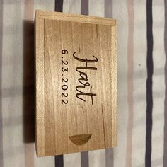 a wooden plaque that says happy new year on the side of a striped wallpaper