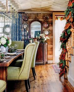 the dining room table is set with green chairs