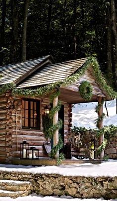 a log cabin in the woods with snow on the ground