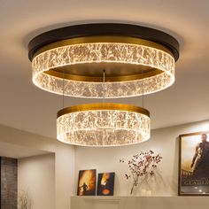 a living room filled with furniture and a chandelier hanging from the ceiling over a fire place