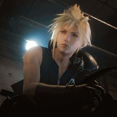 an image of a man with blonde hair and leather gloves in a dark room looking at the camera