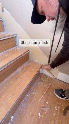 a man in black shirt and hat working on wood floor next to stairs with text saying skiring in a flash