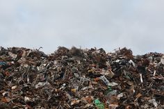 a large pile of trash sitting on top of a field