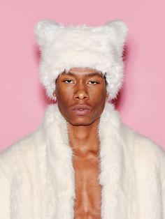 The signature hat style of the capsule features a square silhouette that, when worn, appears subtly as two ears. Crafted of soft faux fur, it has a textural feel that adds volume to the silhouette. Sourced from the leading ethical fur manufacturer, ECOPEL, this luxurious fiber is crafted with sustainability in mind as a worthy alternative to animal-sourced fur. Designed with a soft and lustrous feel, it is the optimal fabrication for the Faux Fur Hat and Faux Fur Jacket in which it features, ens Fur Trench Coat, Faux Fur Hat, Rosetta Getty, Hat Style, Fur Hat, Faux Fur Jacket, Trench Coats, Square Shape, Fur Jacket