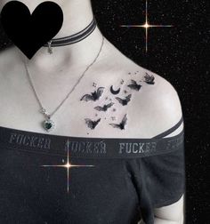 a woman wearing a black shirt with butterflies on her chest and stars in the background