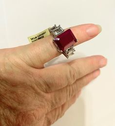 This is a beautiful piece of vintage jewelry. The rubellite is an emerald cut lab simulated gem with 2 clear Topaz on each side. The band is 925 Stealing silver, it is also marked STS which means it comes from a very reputable jewelry company.  It is pre-owner but not worn. This came from an Estate and the ring was purchased sometime in the before 2005.  Size 7, the size of the stone is approx. 56 inches x .43 inches and sits up from the finger .41 inches. Jewelry Companies, Emerald Cut, Rings Statement, Sterling Silver Ring, Statement Rings, Silver Ring, Topaz, Sterling Silver Rings, Vintage Jewelry