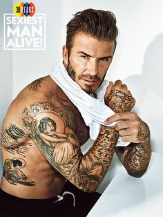 a man with tattoos on his arms and chest