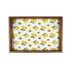 a tray with lemons on it and green leaves in the middle, against a white background