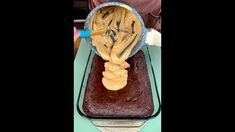 a cake in a pan with a spoon sticking out of it