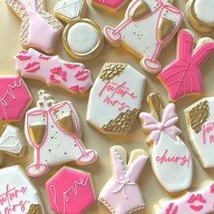 decorated cookies with pink and white icing on a table