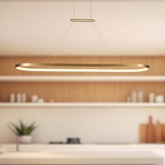 a modern kitchen with wooden cabinets and white counter tops, an overhead light fixture hangs from the ceiling