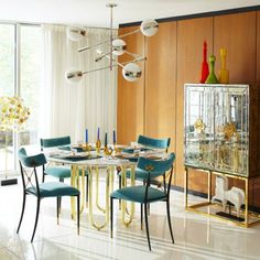 a dining room table with blue chairs around it