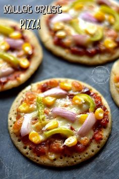 four small pizzas with different toppings on them