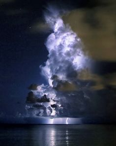 a lightning storm is seen over the ocean