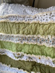 a quilted bed with green and white ruffles