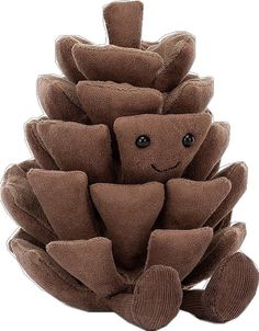 a stuffed pine cone with a smiling face on it's side, sitting in front of a white background