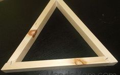 a wooden triangle sitting on top of a table