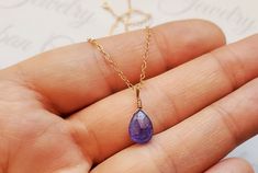 Genuine Purple Dainty Tanzanite Gemstone Necklace, December Birthstone Jewelry, Authentic Tanzanite Jewelry, 14k Gold Tanzanite Necklace This dainty necklace features a genuine faceted purple Tanzanite gemstone wire wrapped on a delicate yet sturdy dainty chain. This stone measures at 8x6x5mm and also comes gift wrapped for free. Perfect gift for any lady who loves purple tanzanite or born in December. Materials - your choice of sterling silver, 14k gold filled, 14k rose gold filled and genuine Faceted Tanzanite Jewelry For Gifts, Dainty Tanzanite Birthstone Jewelry, Faceted Tanzanite Jewelry Gift, Tanzanite Briolette Necklace Gift, Tanzanite Faceted Necklace For Gift, Briolette Tanzanite Necklace For Gift, Gift Tanzanite Faceted Necklace, Purple Tanzanite, Born In December