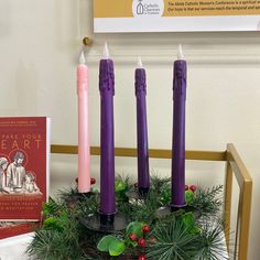 purple candles are arranged in a wreath on a table